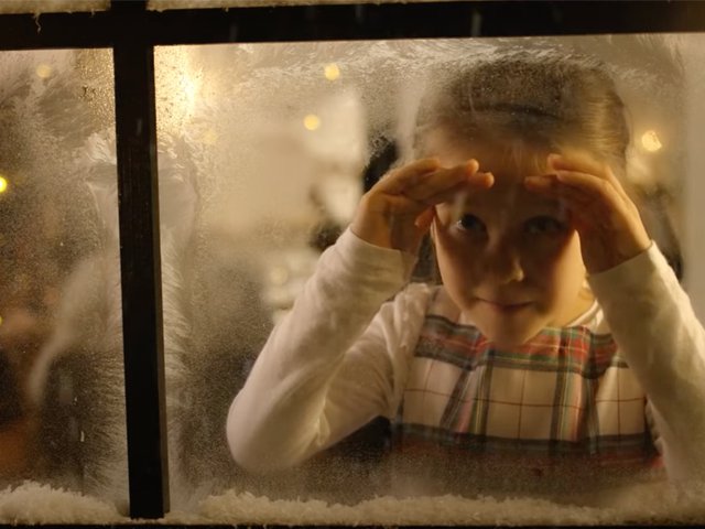 Girl at snow-covered window.png